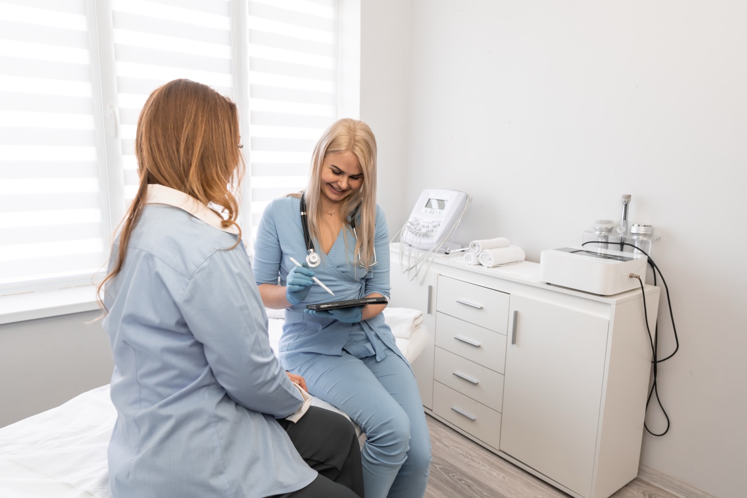 A clinician and patient reviewing information on a tablet