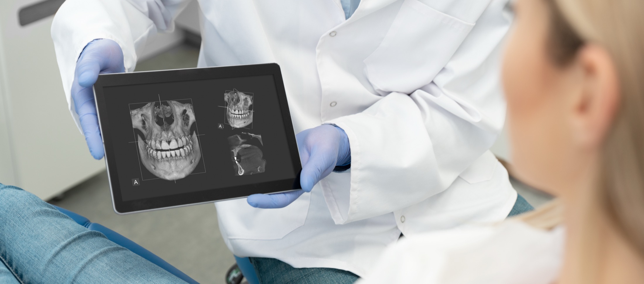 A dentist reviewing a 3D dental scan with a patient